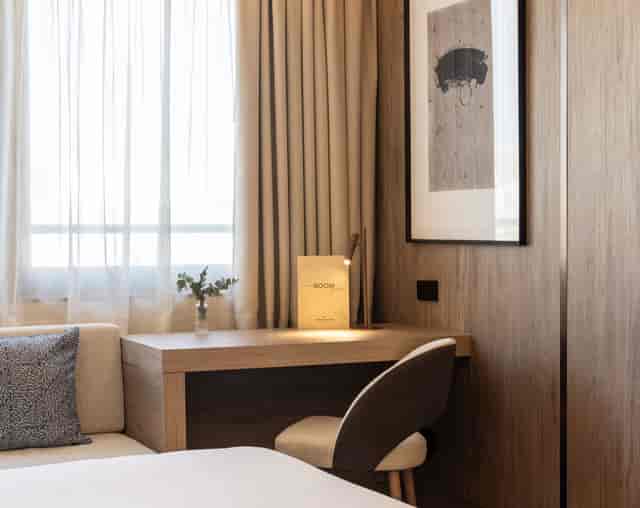 Elegant hotel room with workspace, ideal for business meetings in Madrid.