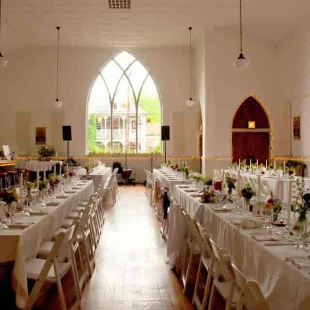 Elegant wedding venue with arched windows and soft lighting for formal gatherings.
