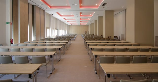 Spacious conference room at Hotel Riu Plaza España for corporate events and training sessions.