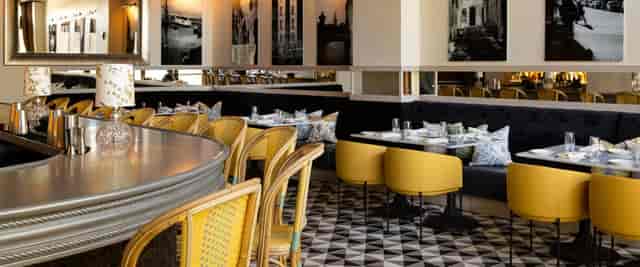 Stylish cafe at Bistro Du Midi, vibrant decor for intimate gatherings and upscale brunches.