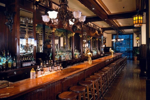 Elegant bar at Old Ebbitt Grill, rich wood finishes for networking events and receptions.