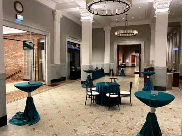 Elegant conference room with teal tables, perfect for receptions and networking events.