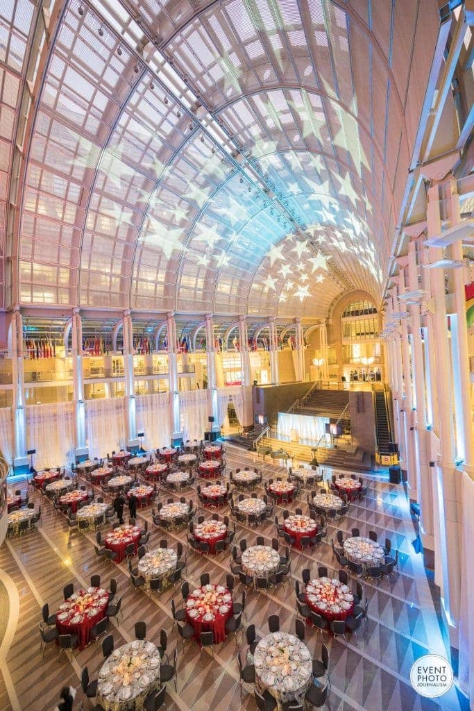 Elegant event space with round tables in Ronald Reagan Building for conferences and galas.