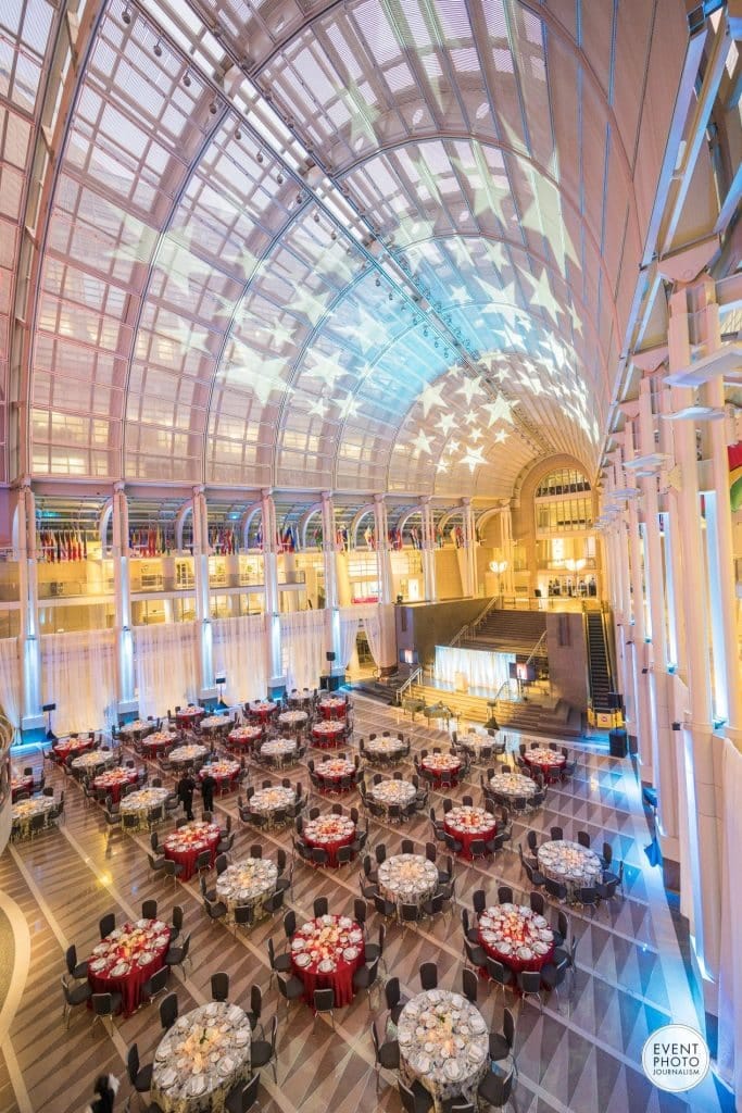 Elegant event space with round tables in Ronald Reagan Building for conferences and galas.