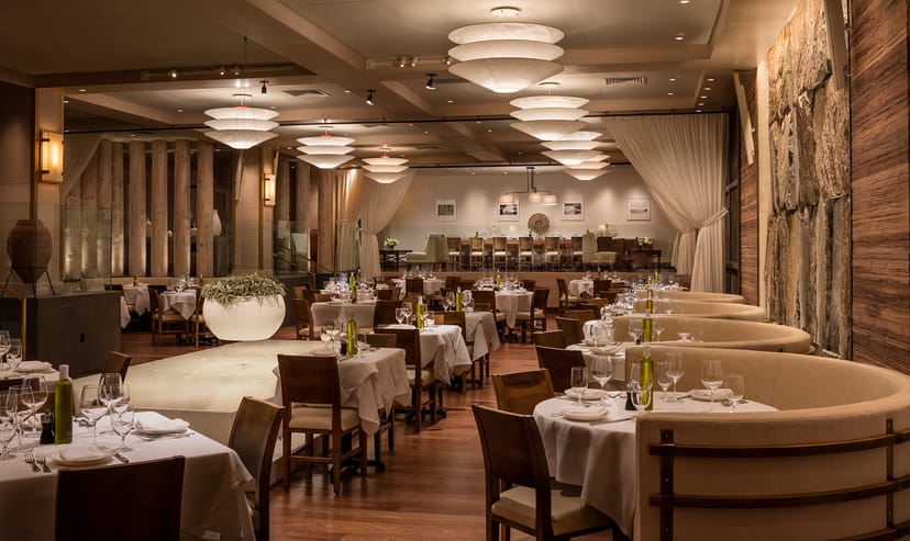 Upscale dining at Avra Madison with elegant tables and warm ambiance for events.