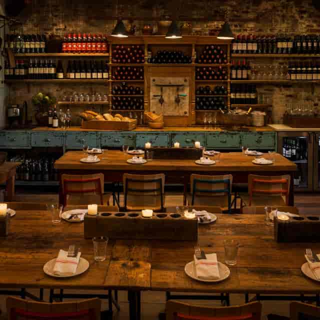 Rustic dining setup with wooden tables for intimate gatherings and corporate events.