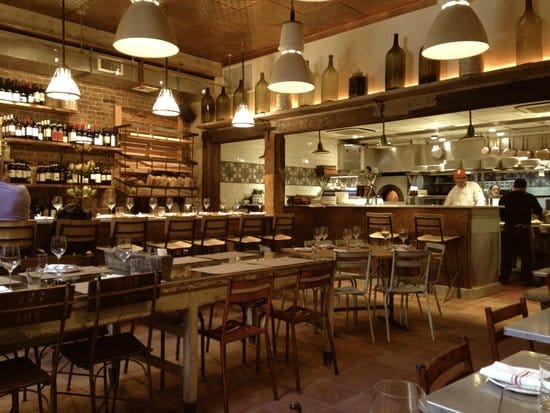 Cozy salumeria with rustic decor for events and wine tastings at il Buco Alimentari.