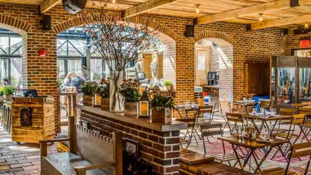 Rooftop Bar at Refinery Hotel: rustic venue with warm brick walls for corporate events.