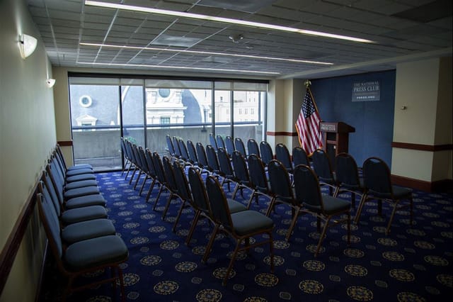 First Amendment Lounge meeting space, podium setup for professional events, natural light