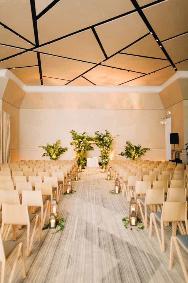 Elegant ceremony setup with floral arch and wooden chairs at The William Vale conference room.