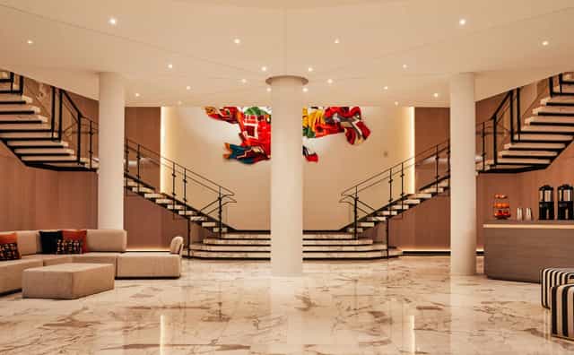 Elegant Vale Ballroom lobby with dual staircases for corporate events and meetings.