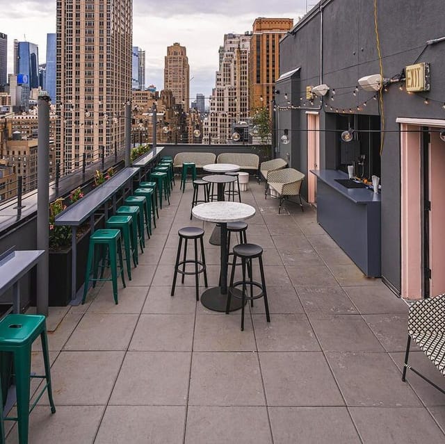Elegant rooftop lounge with marble tables, ideal for upscale receptions and cocktail parties.