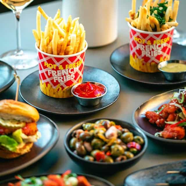 Rooftop terrace dining with crispy fries, ideal for informal meetings and events.