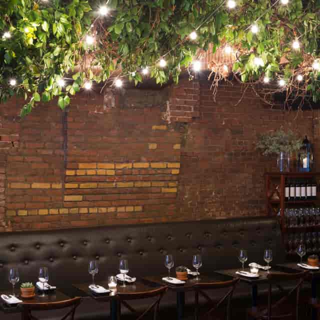 Intimate dining room with exposed brick, perfect for networking receptions and private events.