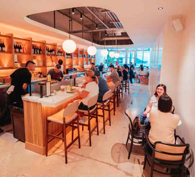 Vibrant coffee shop Emissary with warm lighting, ideal for networking events.