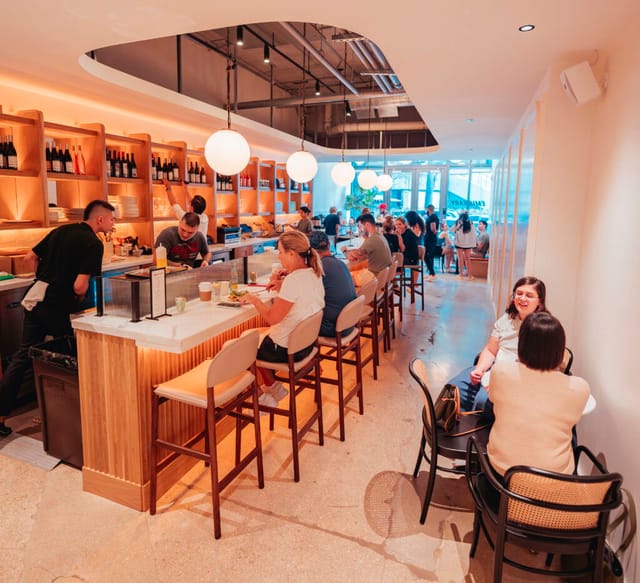 Vibrant coffee shop Emissary with warm lighting, ideal for networking events.