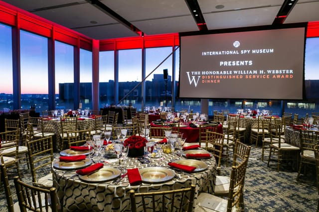 Elegant event space with round tables for a prestigious award dinner in Emissary.