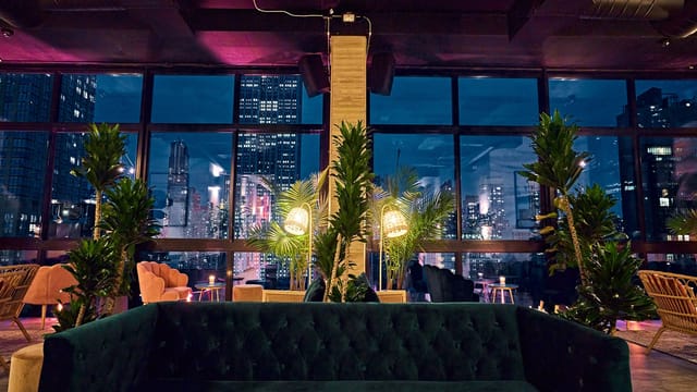 Stylish event space at Isla & Co. with city skyline, perfect for networking and gatherings.