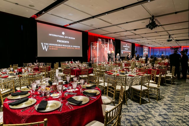 Elegant ballroom banquet setup for high-profile awards event at International Spy Museum.