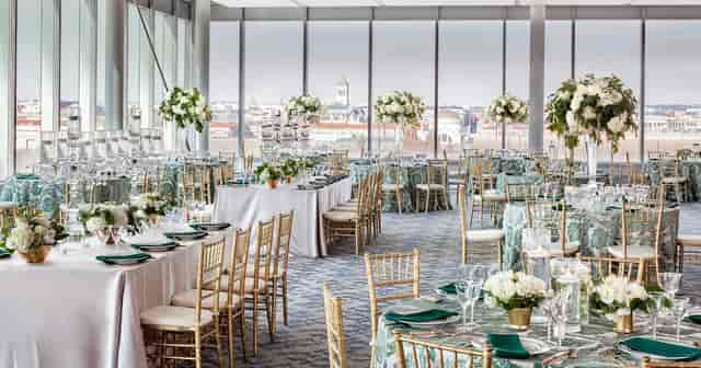 Private event space with elegant tables and floral centerpieces at International Spy Museum.