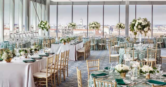 Private event space with elegant tables and floral centerpieces at International Spy Museum.