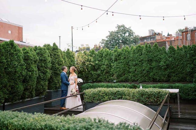 Outdoor wedding venue with lush greenery and modern architecture at Fathom Gallery.