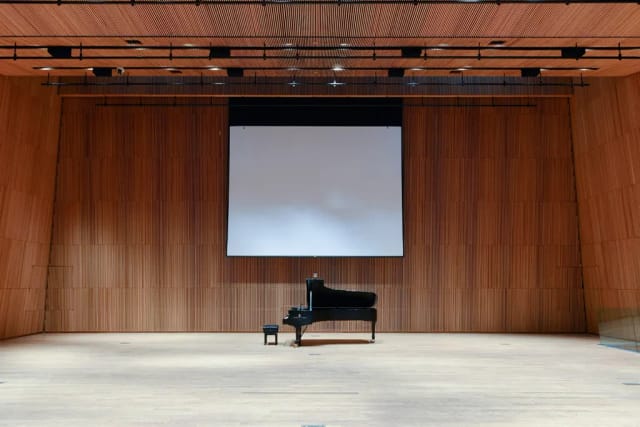 Concert Hall stage with grand piano, perfect for concerts and corporate events.