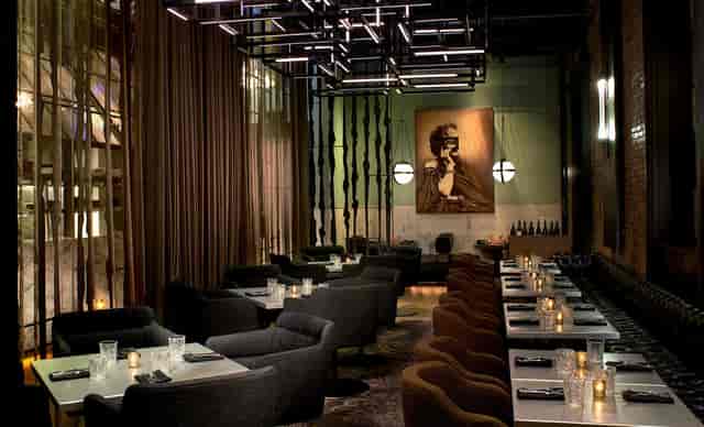 Private dining room with modern decor in Dirty Habit, ideal for upscale events and meetings.