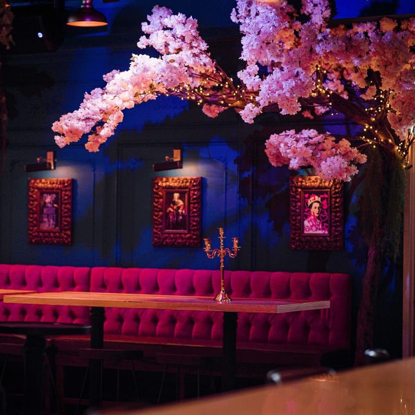 Chic Harlot DC Lounge with pink seating and cherry blossom decor for upscale events.