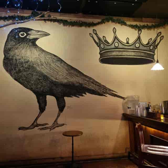 Karaoke event at The Crown & Crow with a large crow mural backdrop.