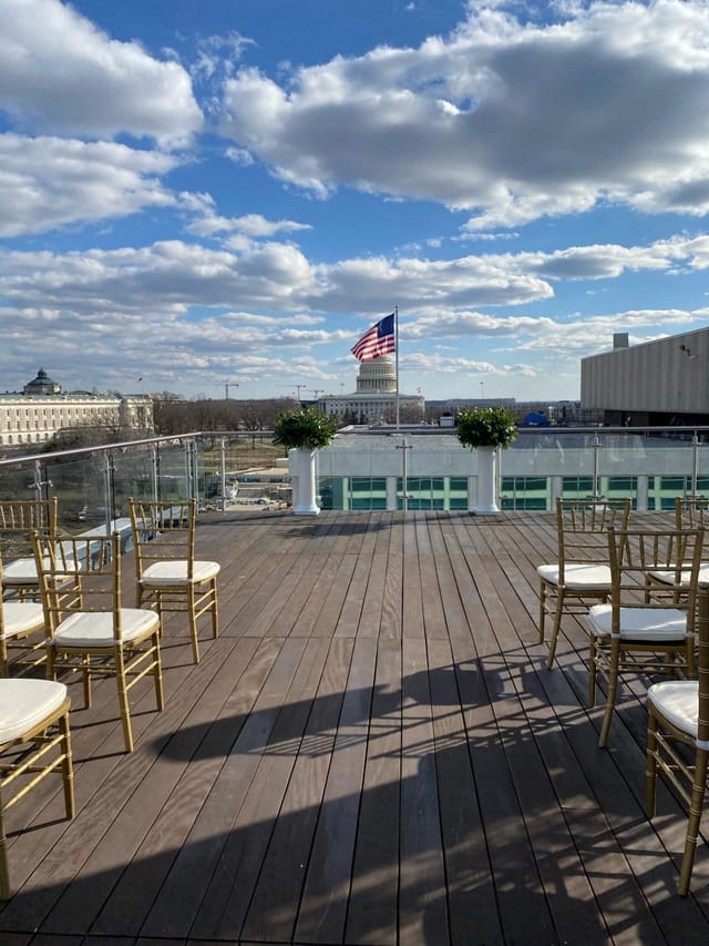 Elegant rooftop event space with gold chairs, U.S. Capitol backdrop, perfect for gatherings.