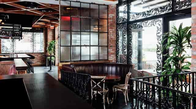 Stylish bar with brick walls, perfect for social events and meetings.