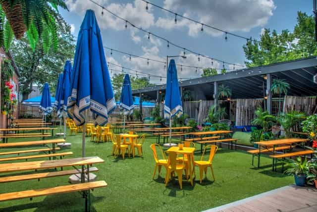 Vibrant Hook Hall garden venue with blue umbrellas, ideal for summer events and gatherings.