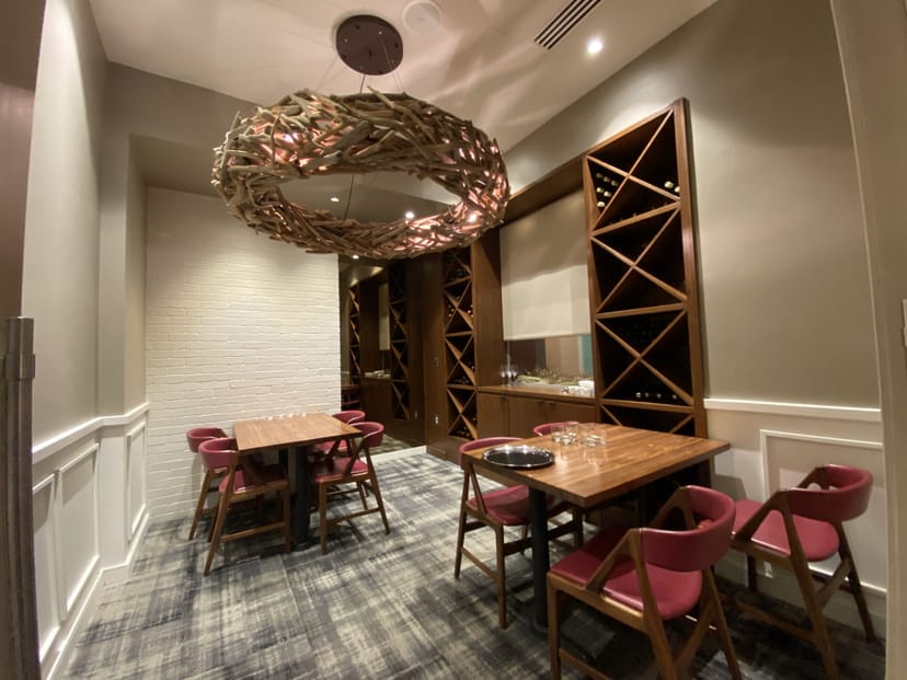 Private dining room at Centrolina with a rustic chandelier for corporate events.