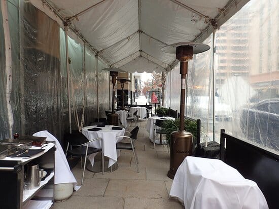Semi-enclosed patio in Modena, featuring elegant dining for brunch and corporate events.