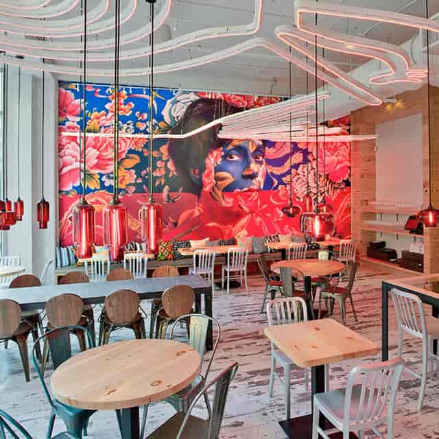Vibrant Dining Room at China Chilcano with floral mural, ideal for meetings and gatherings.