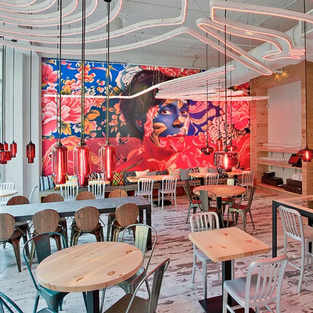 Vibrant Dining Room at China Chilcano with floral mural, ideal for meetings and gatherings.