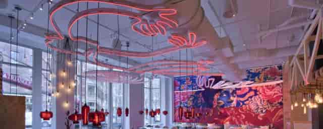 Vibrant China Chilcano event space with neon decor, perfect for networking and gatherings.