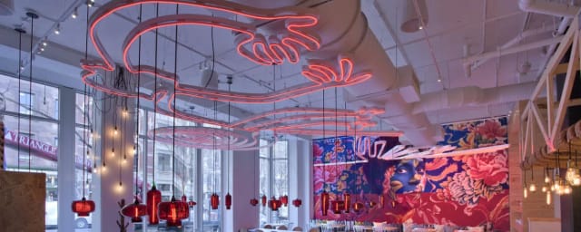 Vibrant China Chilcano event space with neon decor, perfect for networking and gatherings.