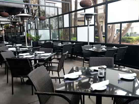 Outdoor dining area at The Daily Grill, featuring sleek tables for business meetings and receptions.