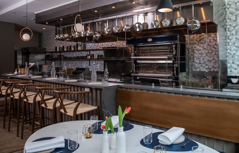 Back Bar at The Henri DC: modern event space with sleek kitchen, ideal for gatherings and networking.