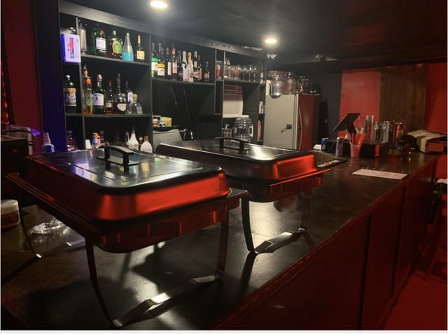 "Elegant bar setup at STUDIO R RedRoom for intimate events and catering"