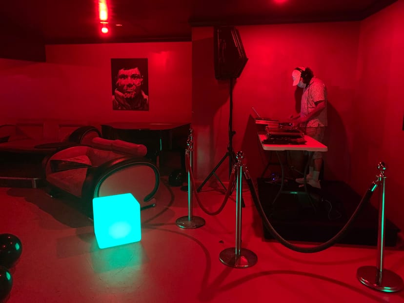 Vibrant red-lit STUDIO R lounge, perfect for intimate events and after-parties.