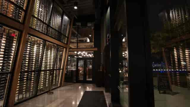 Mezzanine at District Winery: elegant venue with wine racks for corporate events and fine dining.