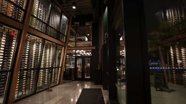 Mezzanine at District Winery: elegant venue with wine racks for corporate events and fine dining.