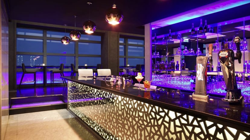 Modern bar in Sofitel Abu Dhabi, sleek design for networking events and cocktail receptions.