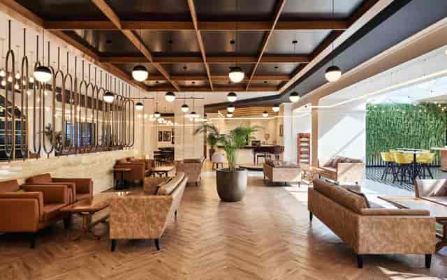 Stylish event space at Fairmont Bab Al Bahr with warm wood accents, ideal for meetings and gatherings.