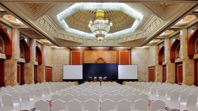 Auditorium at InterContinental Abu Dhabi with elegant chandelier, ideal for conferences.
