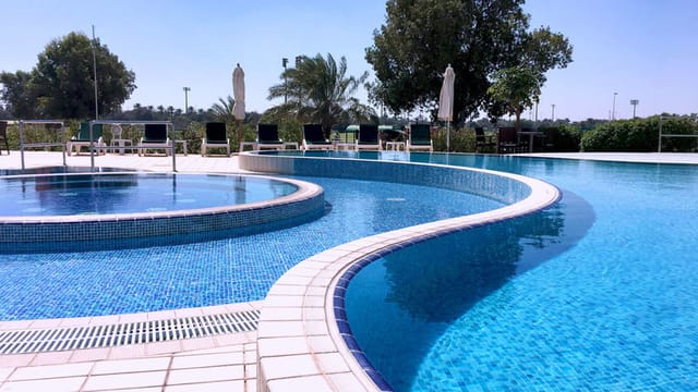 "Beautifully designed pool at Abu Dhabi Golf Club, perfect for outdoor events and networking."