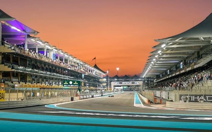 Yas Events Centre at dusk, vibrant racetrack for corporate gatherings and hospitality events.